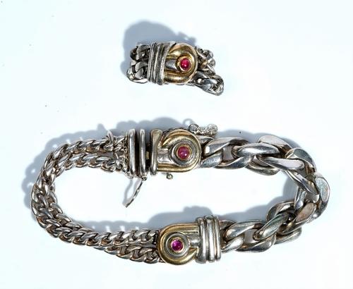 A Gucci silver and silver gilt bracelet and ring suite, the bracelet set with a ruby cabochon link to a heavy flattened curb link bracelet to one side