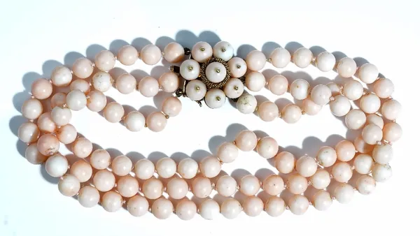 A three row choker of coral beads, on a gold and coral bead cluster clasp, length including clasp 35cm, gross weight 128 gms.