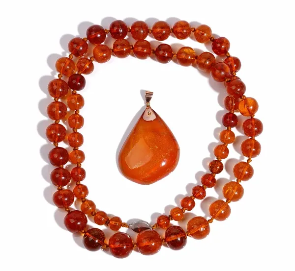 A single row necklace of graduated translucent amber beads on an oval filigree clasp, detailed 925 S, length excluding clasp 82.5cm, gross weight 74 g