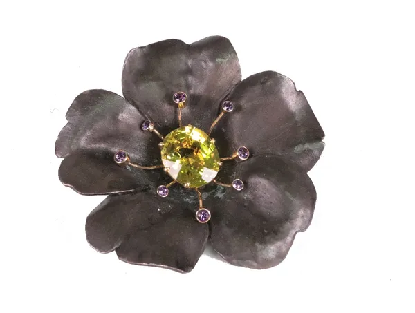 A gold, oxidised silver, citrine and amethyst set brooch of stylized flowerhead design, the oval citrine set with circular cut amethysts to form stame