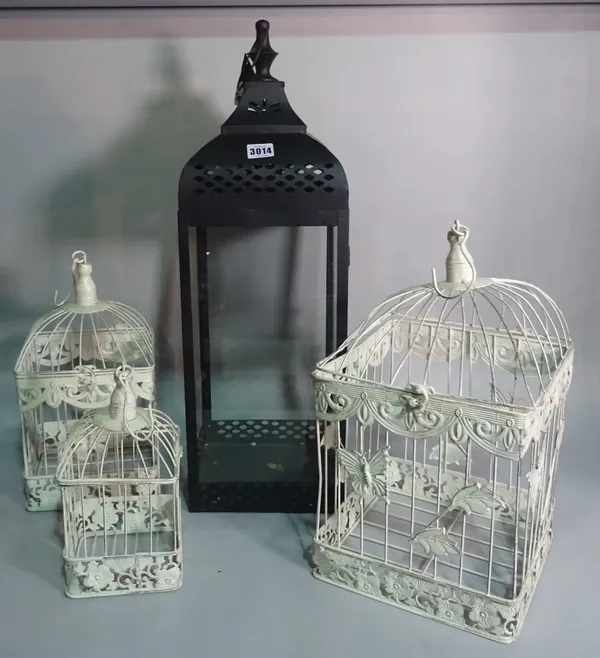 A group of three modern hanging bird cages, the largest 70cm x 21cm and a candle lantern, (4).