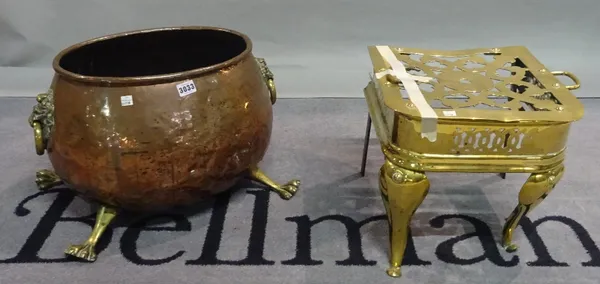 A 19th century copper log bin with brass lion masks, together with a brass trivet stand, 35cm wide x 31cm high (A.F) (2).