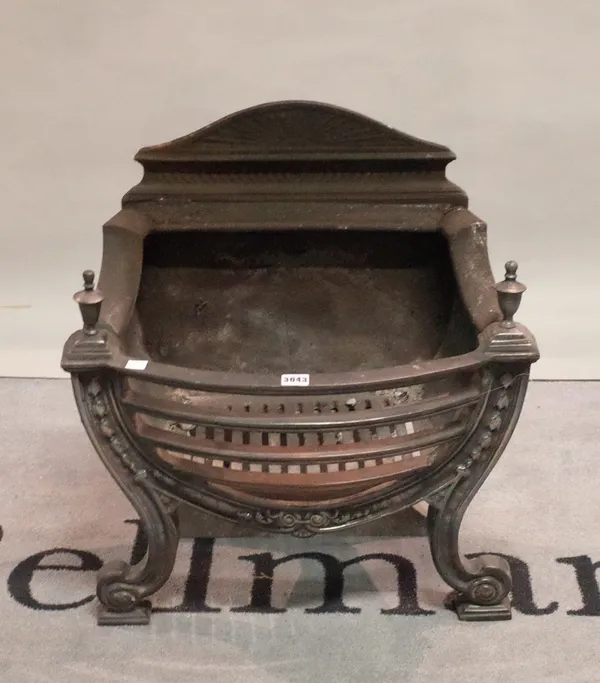 A cast iron bowfront fire basket with tapered finials, 57cm wide.