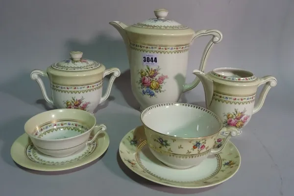 A Limoges floral decorated tea set, comprising 12 cups and saucers, coffee pot and sugar bowl, together with 6 further  similar Limoges cups and sauce