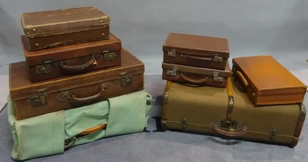 A group of mostly 20th century leather suitcases and travelling trunks, the largest 67cm wide x 20cm high (qty).