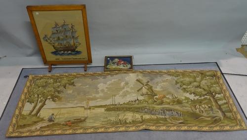 A modern machine made tapestry 182cm wide, an early 20th century oak framed needlework fire screen 50cm wide x 65cm high and another smaller framed ne