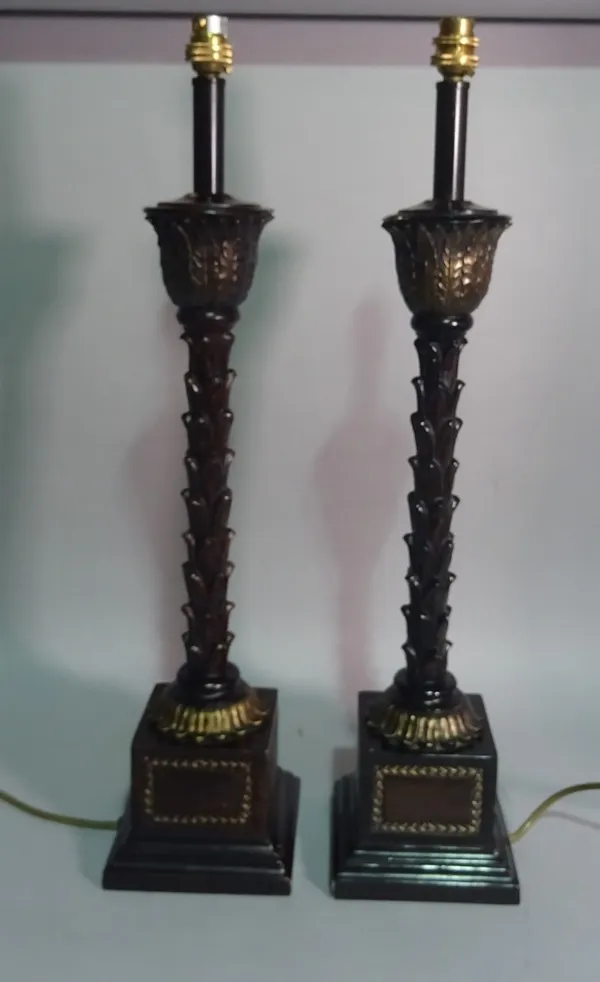 A pair of laquered wooden table lamps of naturalistic form, 62cm wide.