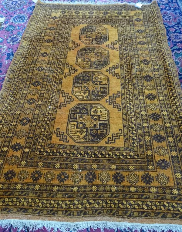 A golden Afghan rug, four large guls, 200cm x 133cm.