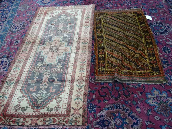 An Afghan Belouch rug, with a diagonal stripped field, 115cm x 68cm.