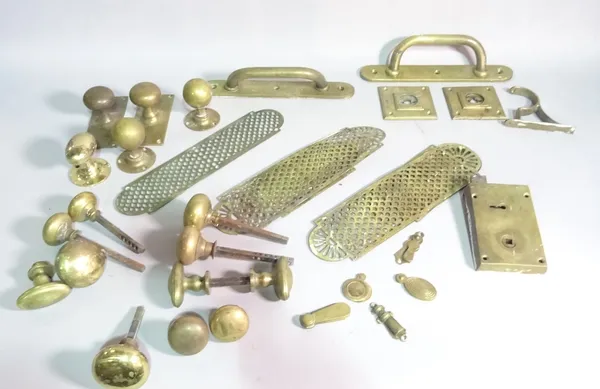 A quantity of early 20th century brass door handles, locks and key escutcheons (qty).