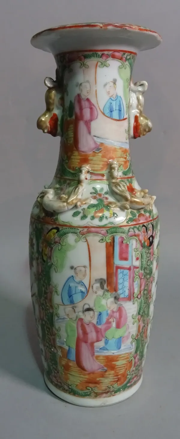 A modern Asian famille rose vase, decorated with figures in an interior scene, 30cm high.