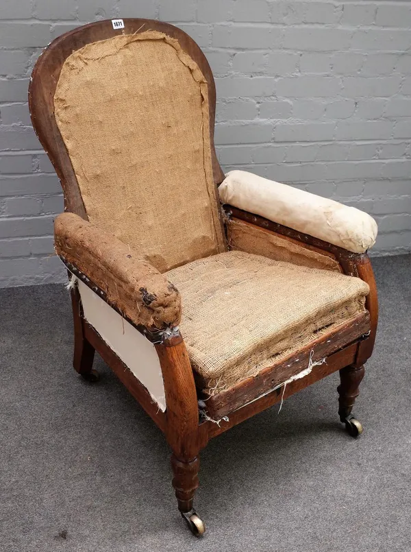 A 19th century oak framed easy armchair with angle adjustable back on turned supports, 70cm wide x 95cm high.