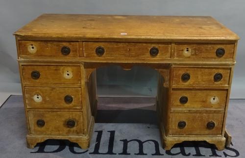 A Victorian pine kneehole desk with drawers about the knee on plinth base, 122cm wide x 72cm high.