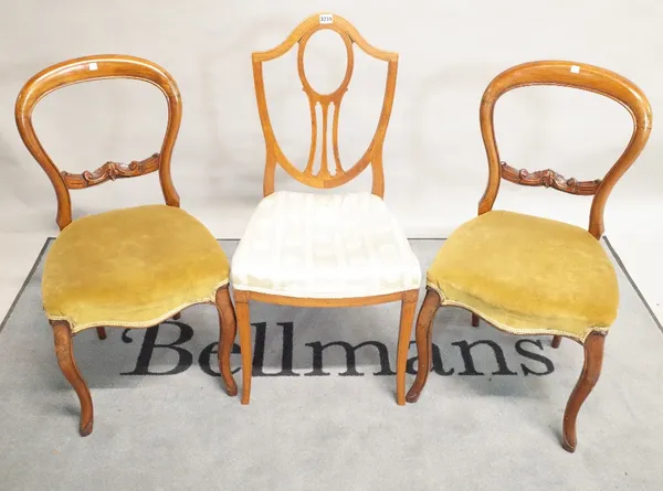 A set of three 19th century satinwood shieldback dining chairs 44cm wide x 94cm high and a pair of Victorian mahogany balloon back dining chairs, 41cm