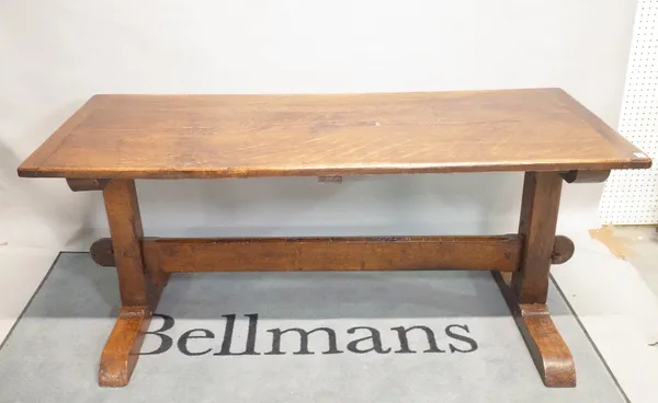 An 18th century style oak refectory table on trestle supports, 176cm wide x 76cm high.