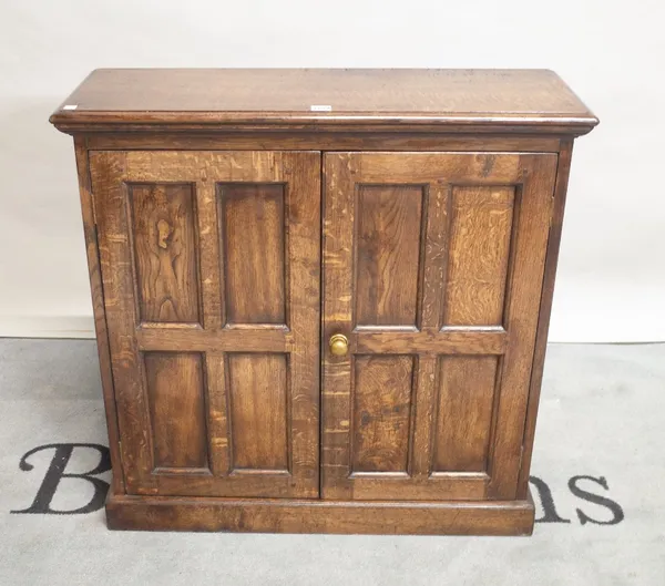 An 18th century style oak two door side cupboard on plinth base, 86cm wide x 85cm high.