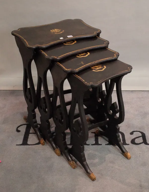 A set of four Chinese export parcel gilt black lacquer occasional tables, on pierced trestle supports, 52cm wide x 73cm high.