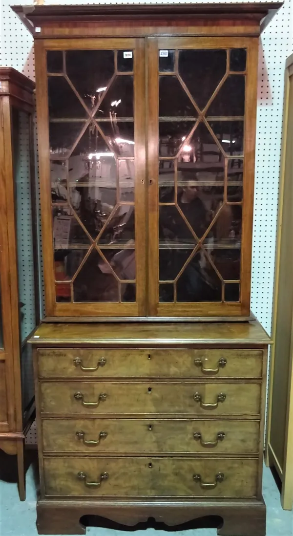 A George III inlaid mahogany bookcase chest, with a pair of glazed doors over four long graduated drawers on bracket feet, 102cm wide x 210cm high.