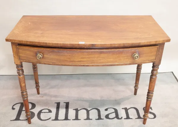 A late Victorian mahogany bowfront two drawer side table on ring turned supports, 106cm wide x 78cm high.