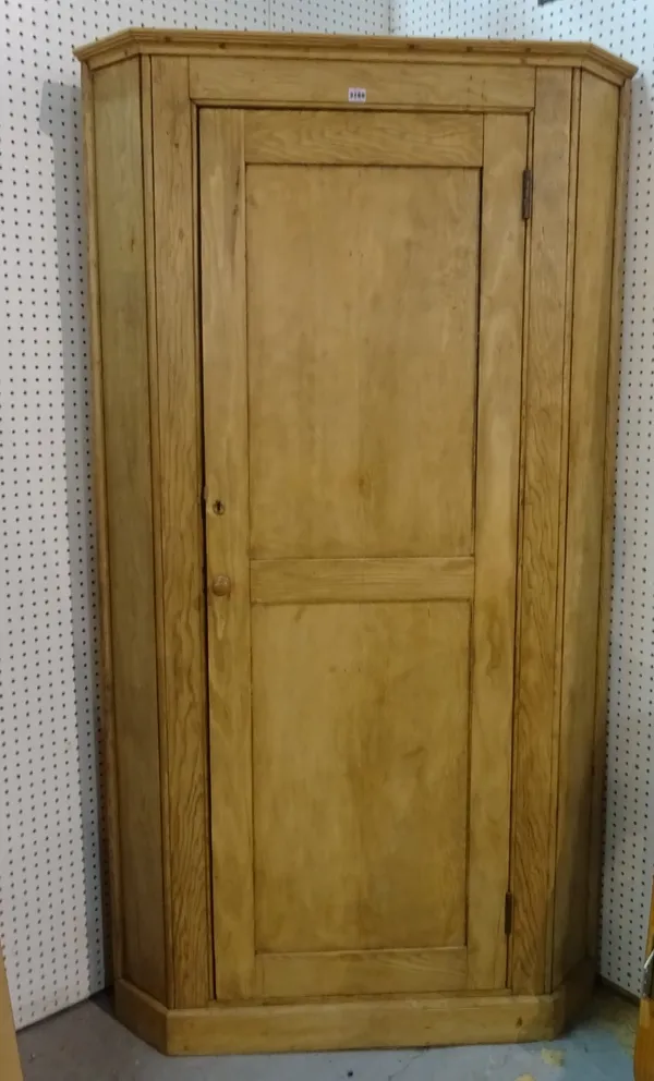 A modern pine floorstanding corner cupboard on a plinth base, 110cm wide x 200cm high.