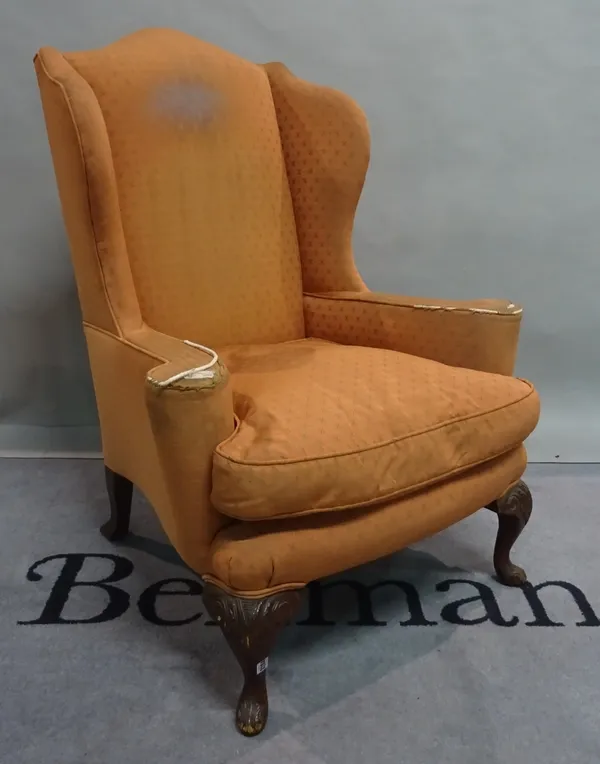 An 18th century style mahogany framed wingback armchair on cabriole supports, 83cm wide x 107cm high.