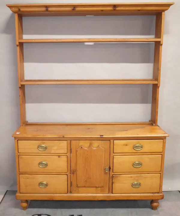 A Victorian pine dresser, the open shelves above a cupboard and six drawers, 152cm wide x 51cm deep x 209cm high.