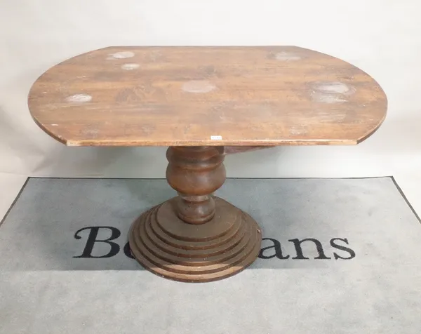 A modern oak centre table on turned column, 138cm wide x 76cm high.