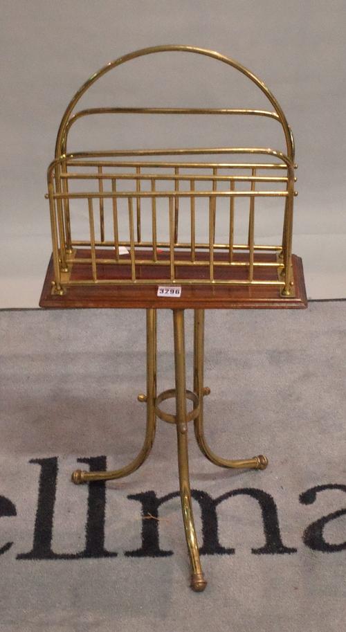 A late Victorian mahogany brass magazine rack with two divisions on tubular tripod base, 36cm wide x 14cm deep x 79cm high.