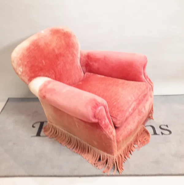 An early 20th century pink upholstered early armchair on turned supports, 98cm wide x 88cm high.