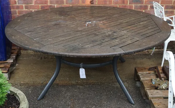 A large slatted circular garden table on four splayed metal supports, 180cm diameter x 75cm high.