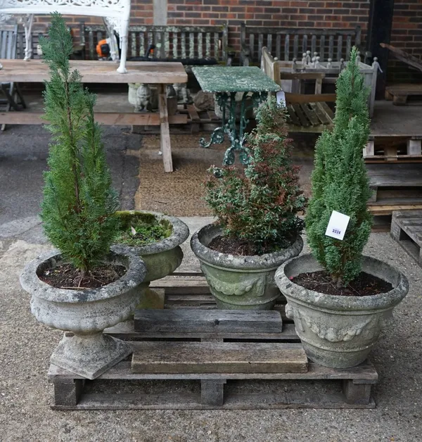 A pair of modern reconstituted stone planters with swag relief decoration, 37cm wide x 54cm high and another pair of reconstituted stone urns, 45cm wi