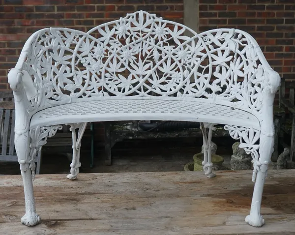 After Coalbrookdale, a white painted concave garden bench, with cast aluminium passion flower pattern, 105cm wide x 86cm high.