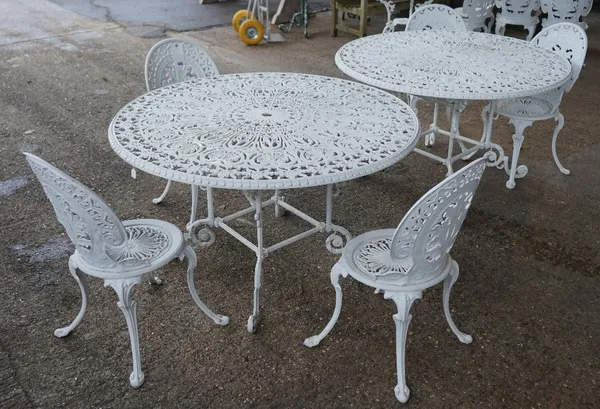 A pair of modern white painted metal circular garden table's, 122cm diameter x 71cm high and a set of five white painted metal chairs, 38cm wide x 80c