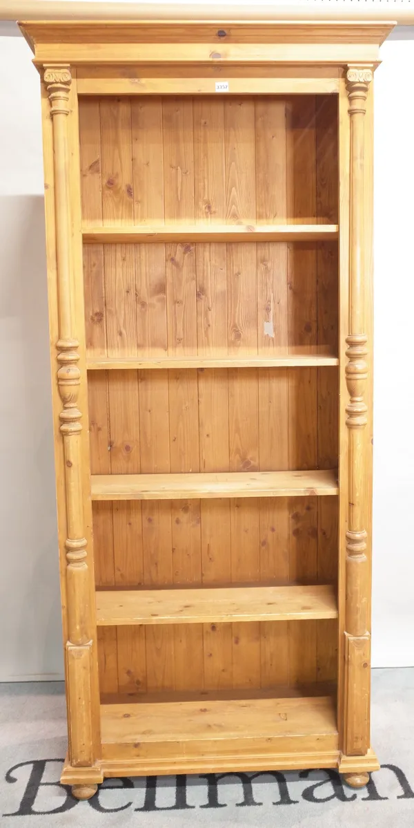 A modern pine floorstanding five tier, open bookcase on bun feet, 92cm wide x 202cm high.