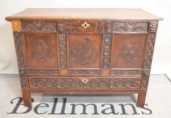 An 18th century style oak mule chest with carved foliate decoration, 116cm wide x 80cm high