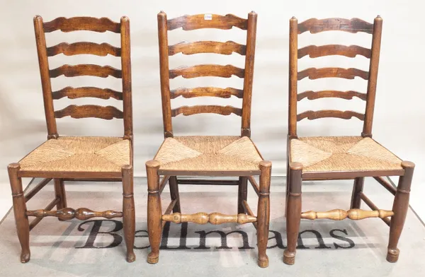 A set of six early 18th century ash and oak ladderback dining chairs, 50cm wide x 100cm high.