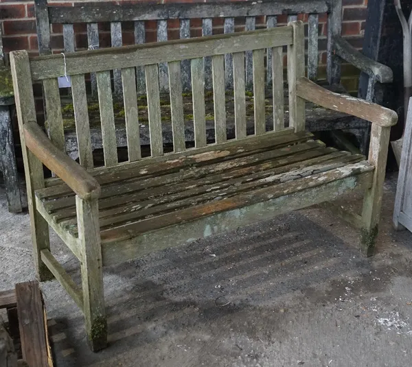 A teak garden bench of slatted construction, 122cm wide x 85cm high.