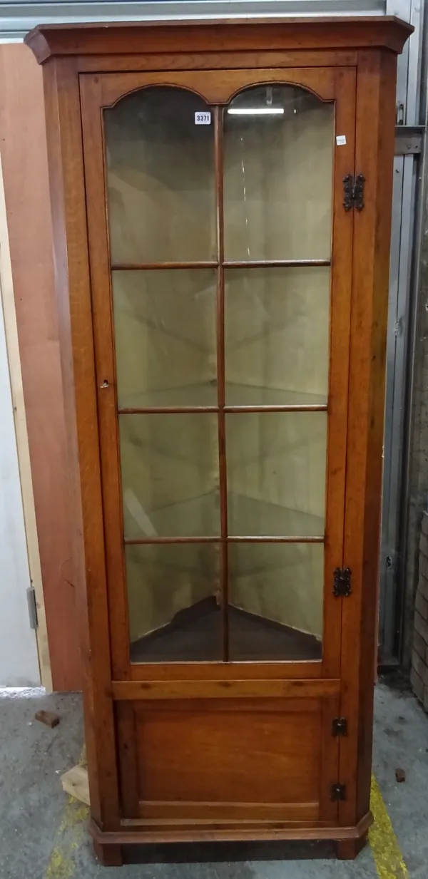 An early 20th century oak glazed floor standing corner cabinet, 78cm wide x 198cm tall.