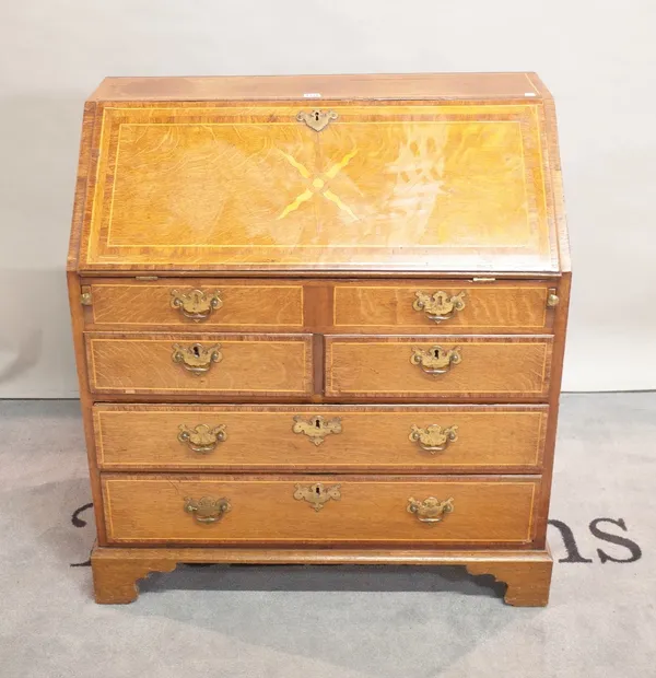 A late 19th century oak bureau with two short and two long drawers on bracket feet, 90cm wide x 100cm high