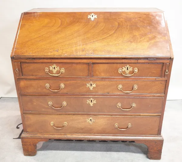 A George III mahogany bureau with two short over three long graduated drawers on bracket feet, 98cm wide x 100cm high.