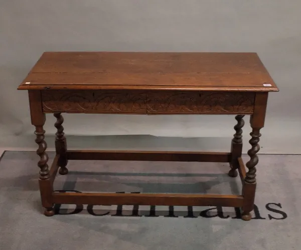 A late Victorian oak two drawer side table on barley twist supports, 114cm wide x 74cm high.