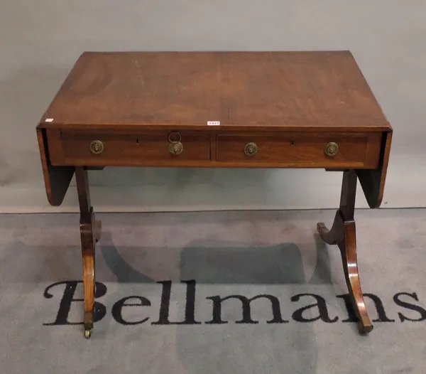 A Regency mahogany sofa table with a pair of frieze drawers, on trestle end standards and four downswept supports, 93cm wide x 73cm high.