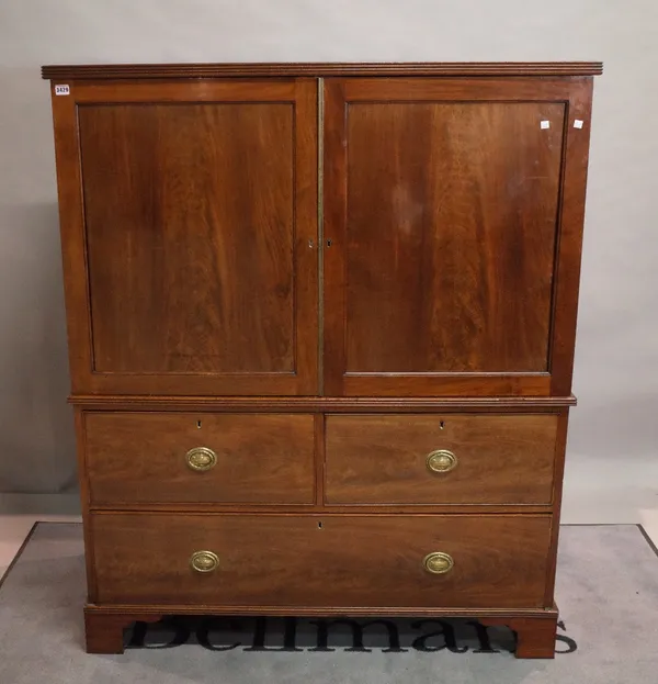 A George III mahogany linen press over two short and one long drawer, 125cm wide x 155cm high.