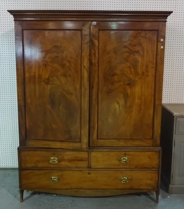 A George III mahogany linen press with moulded cupboard doors over two short and one long drawer, 140cm wide x 183cm high.