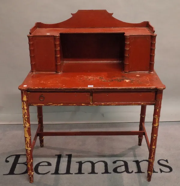 An early 20th century red painted pine dressing table on faux bamboo turned supports, 89cm wide x 113cm high.