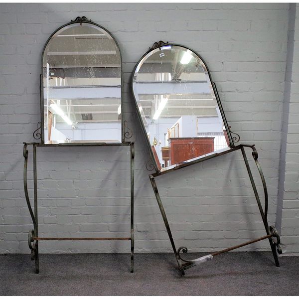 A pair of early 20th century French parcel gilt green painted wrought iron mirror back console tables, 77cm wide x 202cm high.