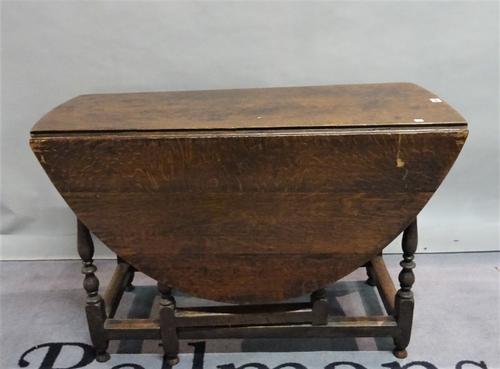 An 18th century and later oak drop flap gate-leg table on turned supports supports, 104cm wide x 69cm high