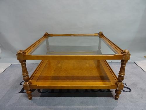 A modern stained beech and walnut two tier square coffee table with glass top, 90cm wide x 51cm high.