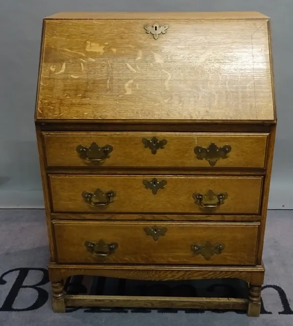 An early 20th century bureau with three long drawers on block supports, 74cm wide x 104cm high.