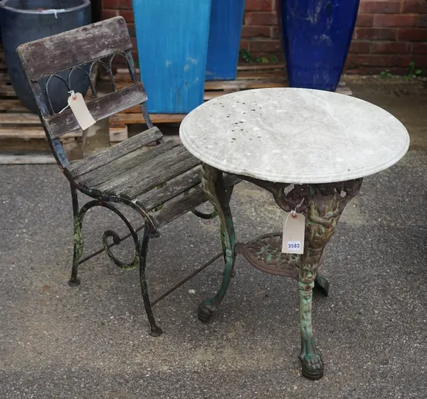 An early 20th century cast iron garden table with associated white marble circular top, 68cm diameter x 72cm high and an early 20th century black pain